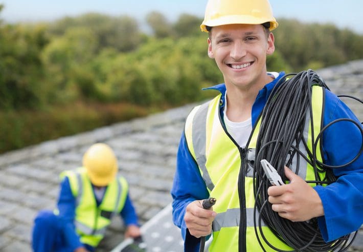Gill Insurance | Worker smiling on rooftop