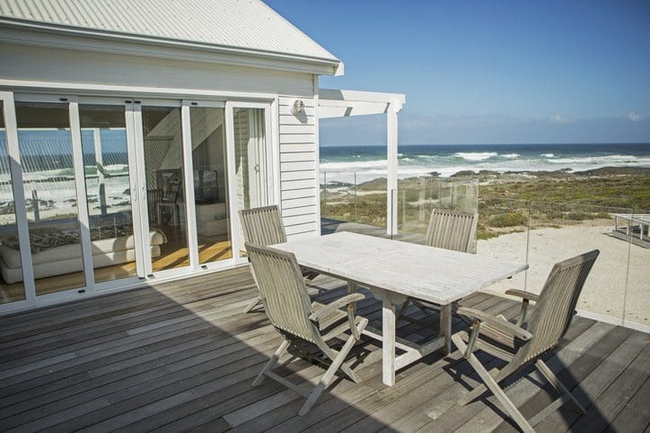 Gill Insurance | Table and chairs on balcony overlooking beach