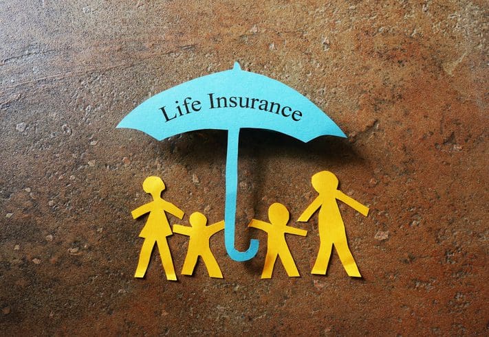 Gill Insurance | Paper family of four under a Life Insurance paper cutout umbrella