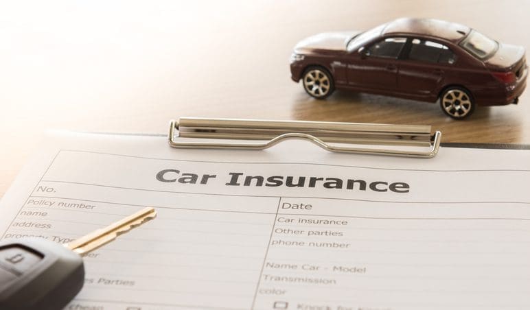 Gill Insurance | car insurance application form with car model and key remote on desk.