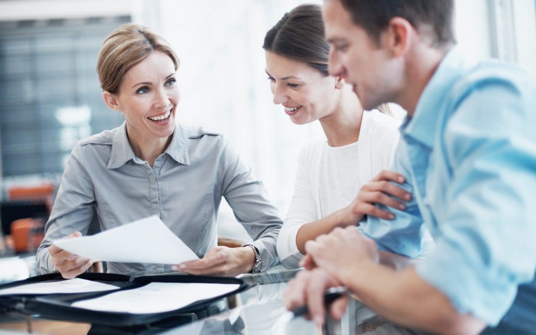 Gill Insurance | Shot of a consultant explaining a document to a young couple