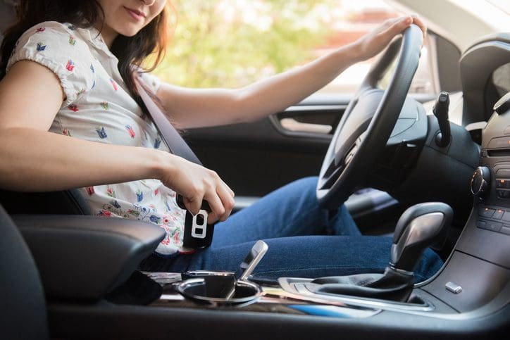 Gill Insurance | Woman buckling her seatbelt in car