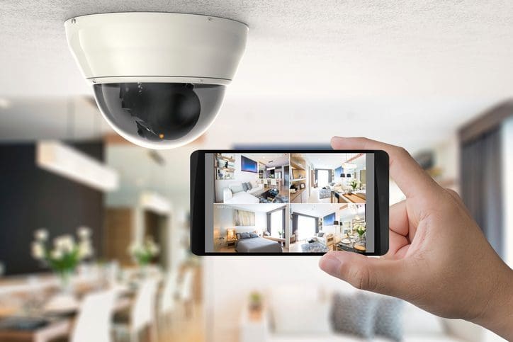 Gill Insurance | hand holding 3d rendering mobile connect with security camera
